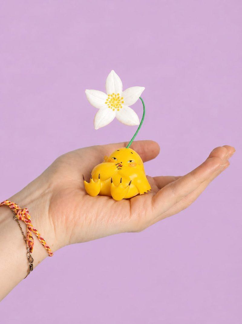 A Humulus figure with a white star flower, held in an open hand